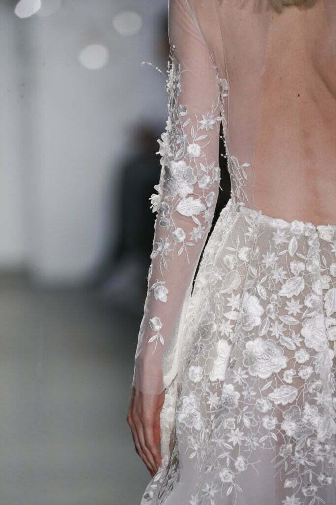 Backless lace gown with white floral embroidery.