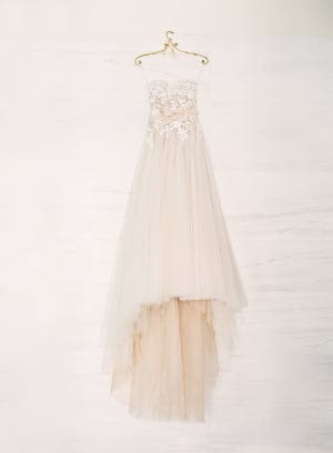 Strapless lace wedding gown with high-low skirt.