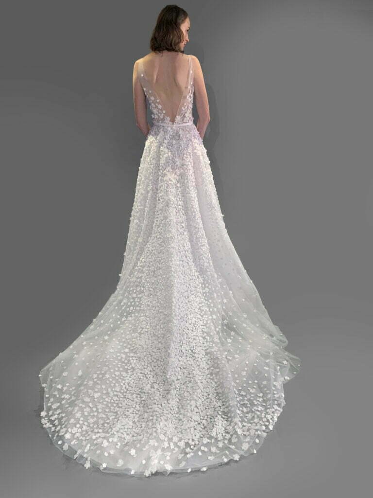 Woman in white gown with floral train.