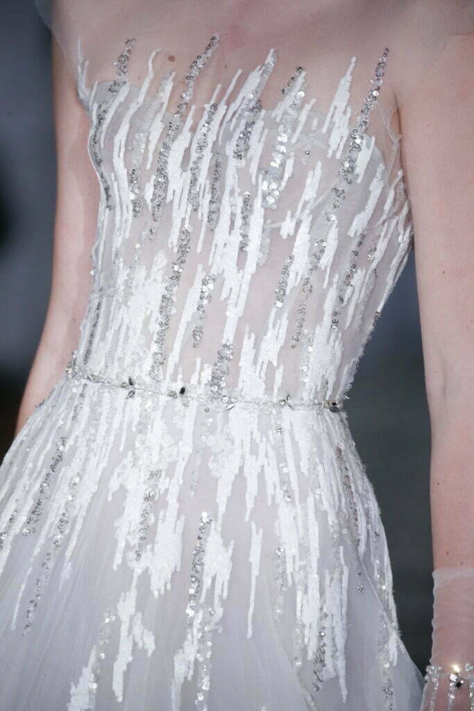 Sheer strapless wedding dress with silver sequins.