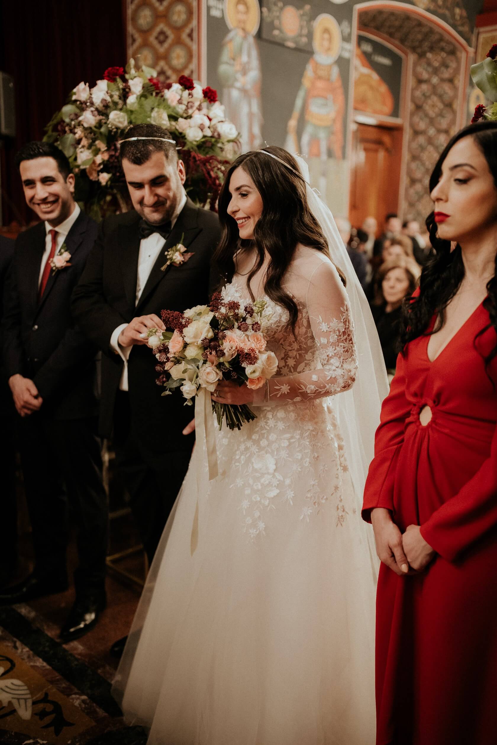 Bride and groom with attendants at ornate wedding.
