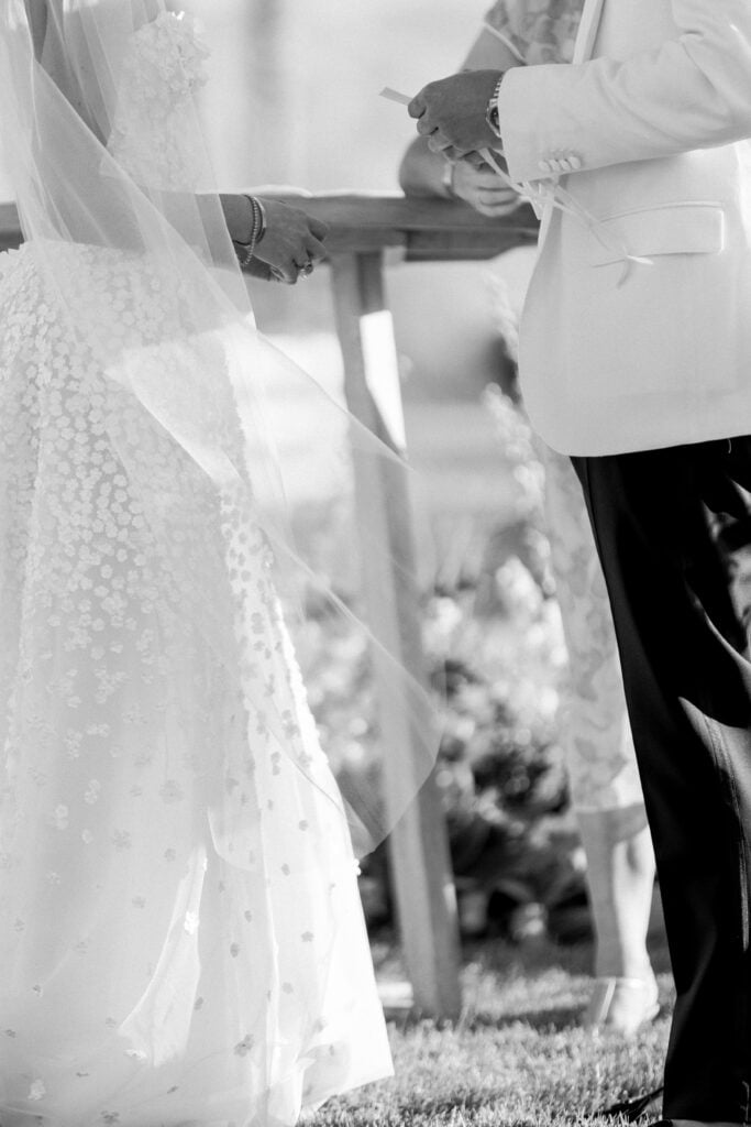 Bride and groom standing close, wedding attire.