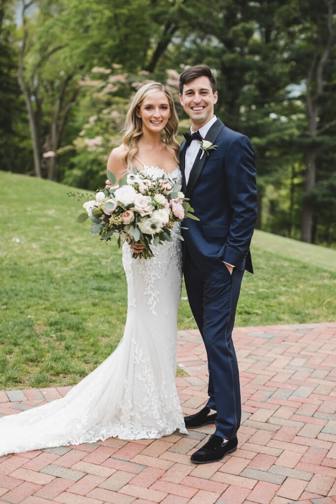 Smiling bride and groom standing outdoors.