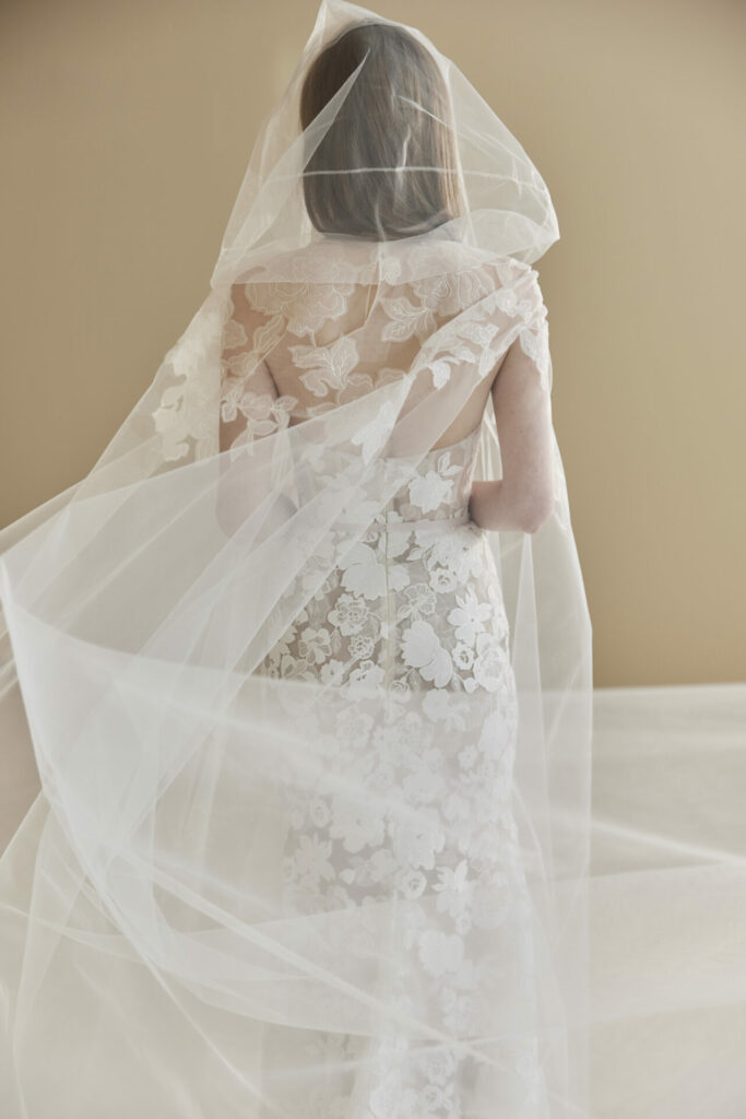 Woman in lace wedding dress and veil.
