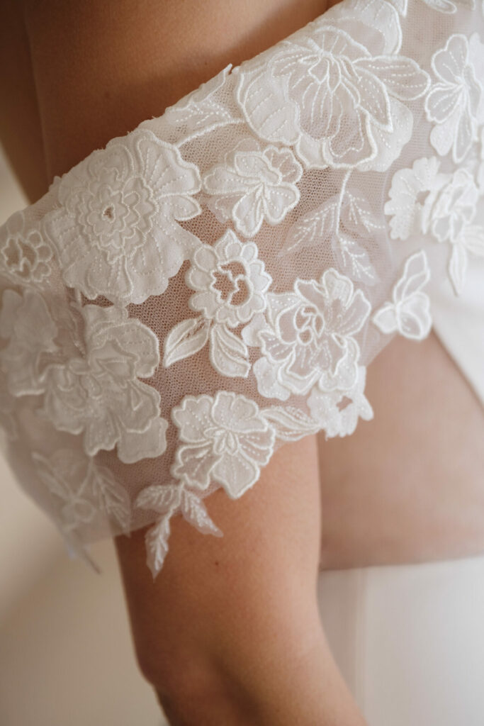 White lace with floral embroidery on shoulder.