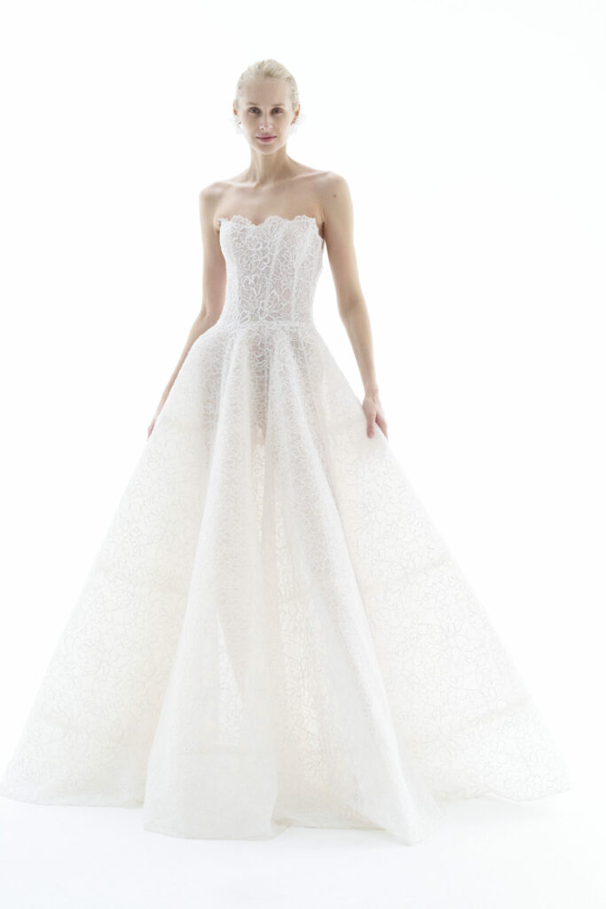 Woman in strapless white lace wedding gown.