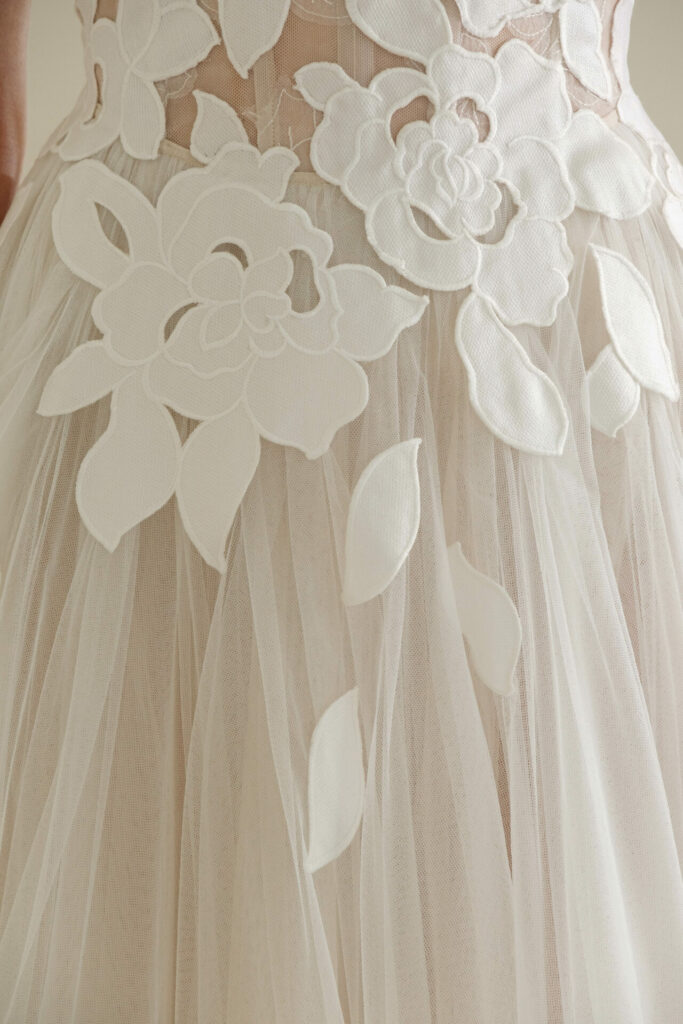 Sheer tulle dress with white floral appliqués.