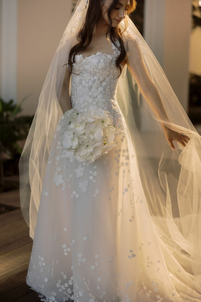 Bride Katya Ruiz in floral embroidered gown outdoors.
