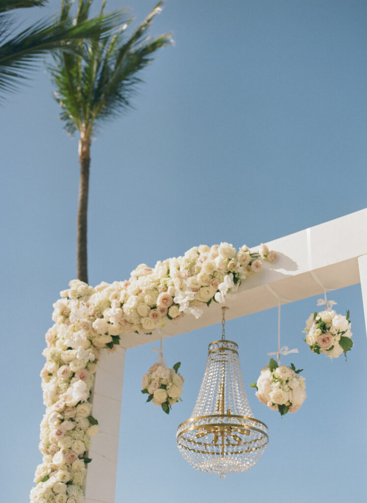 Luxury wedding arch with blush roses outdoors.