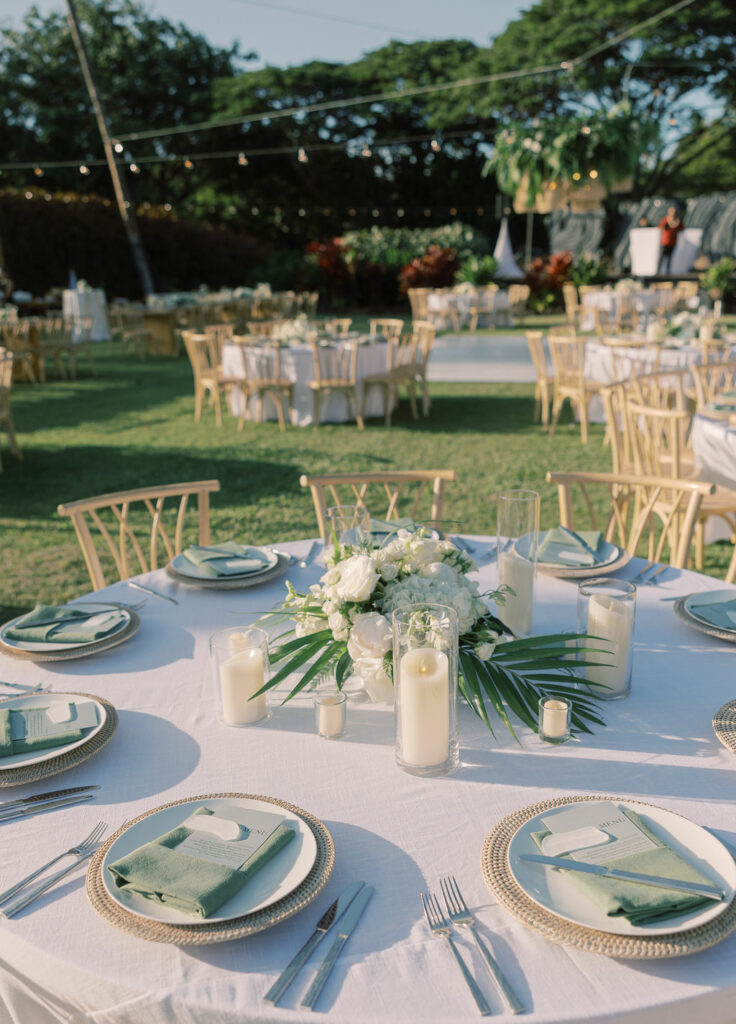 Elegant outdoor tables with florals and string lights.