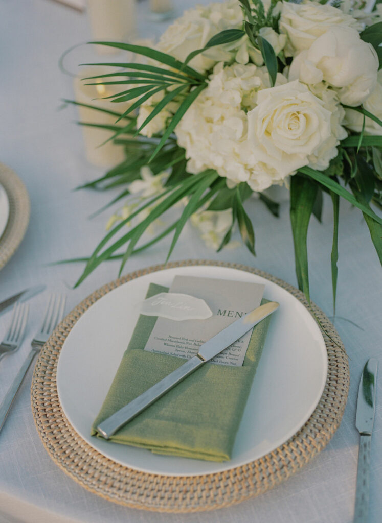 Plate with napkin, menu, name card, flowers.