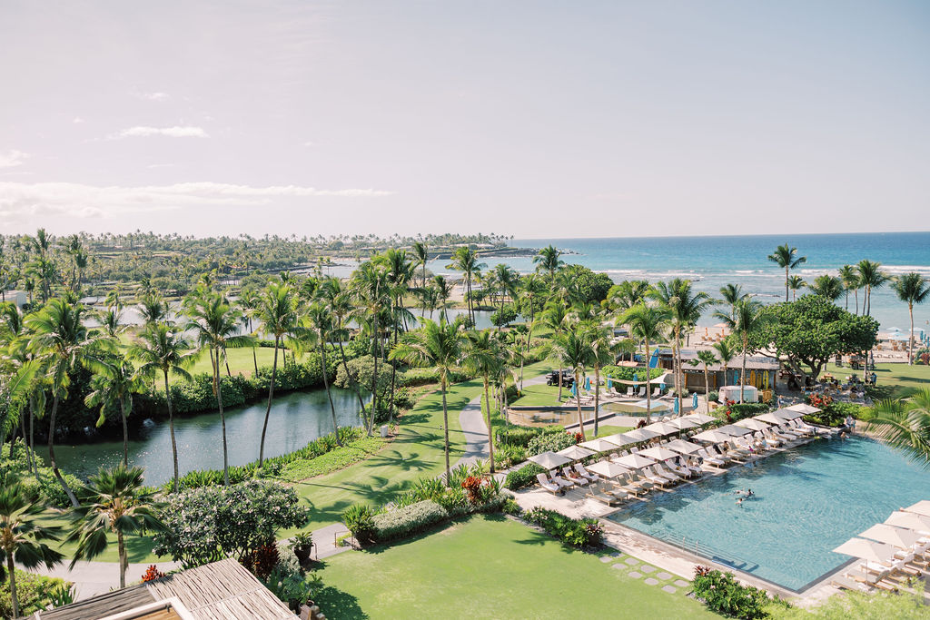 Tropical resort with pool and ocean view.