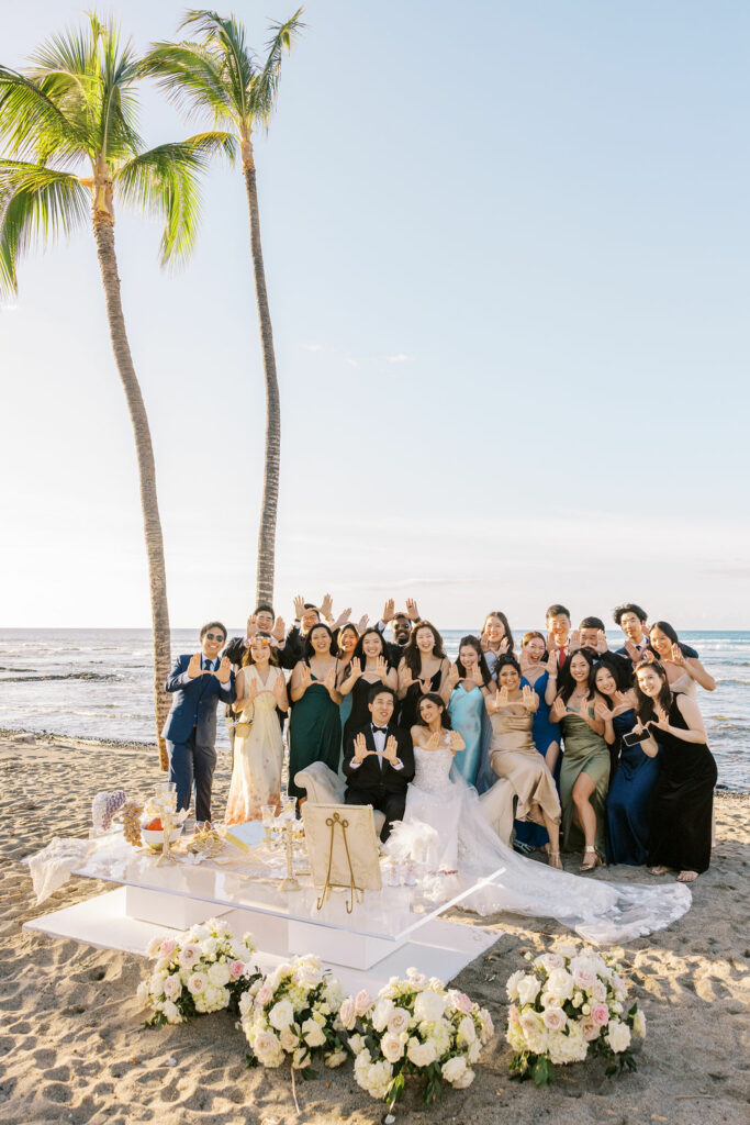 Group in formal wear at beach wedding.