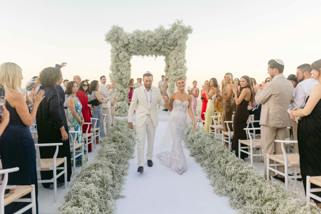 Bride Katya Ruiz exits outdoor ceremony in couture.