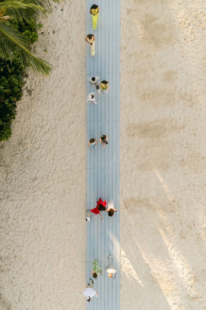Bride Katya Ruiz on blue pathway, beach view.