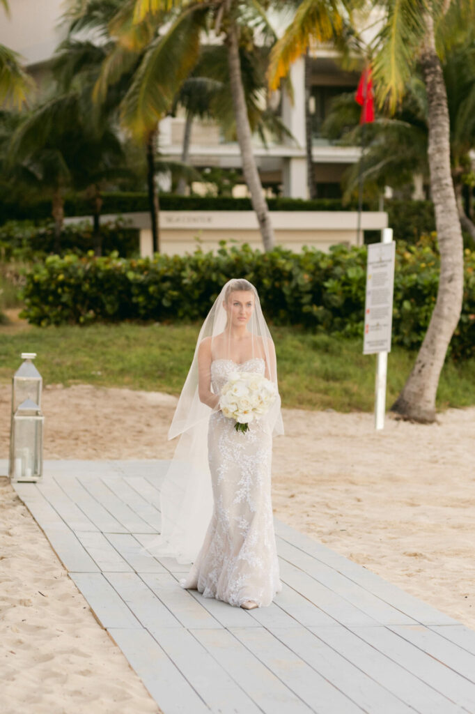 Bride Katya Ruiz in strapless gown, beach path.