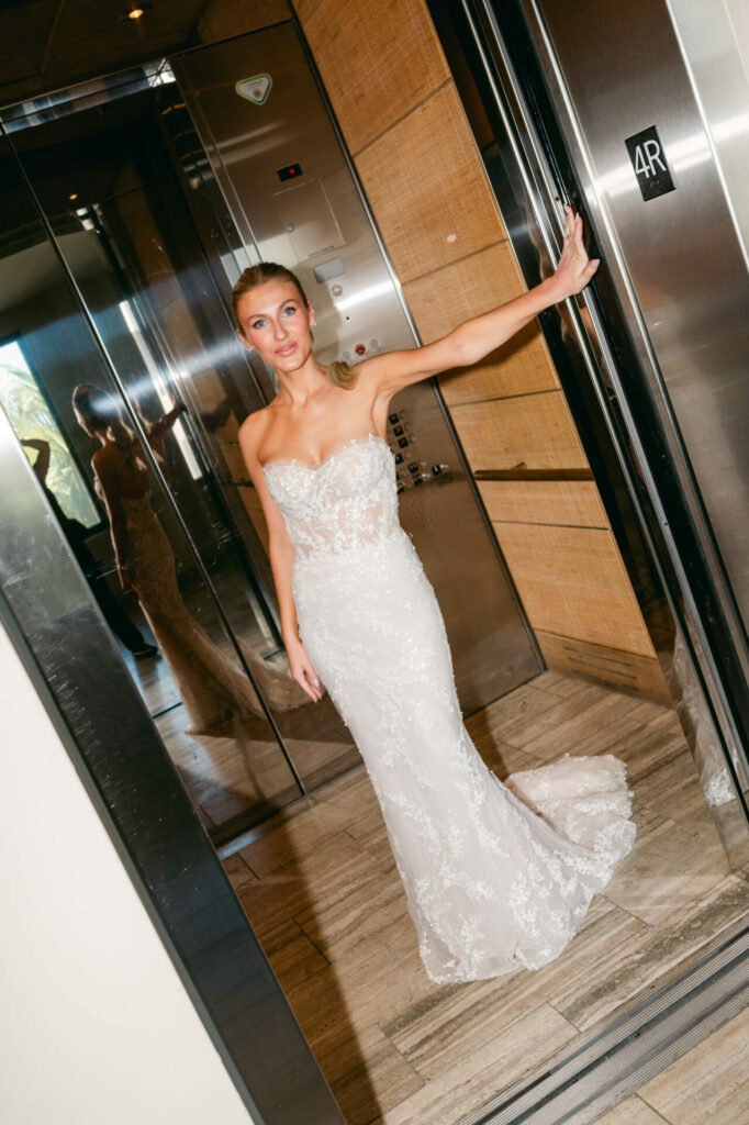 Bride Katya Ruiz in luxury gown, elevator mirror.
