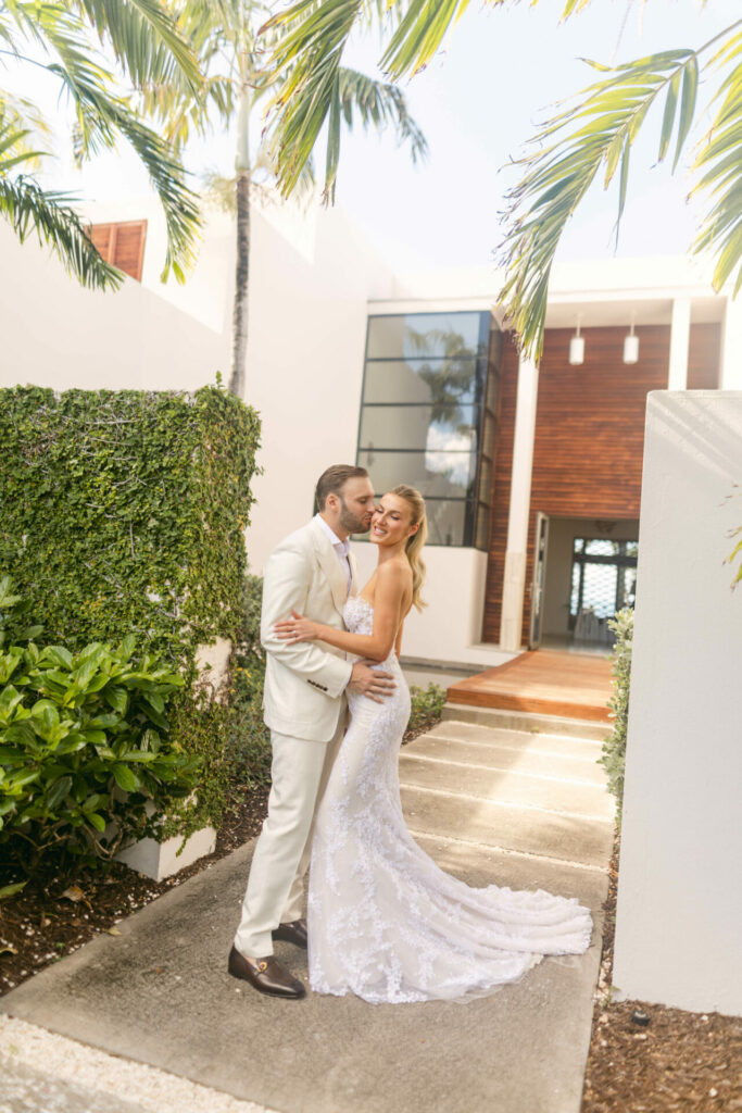 Katya Ruiz and groom embrace in wedding attire.