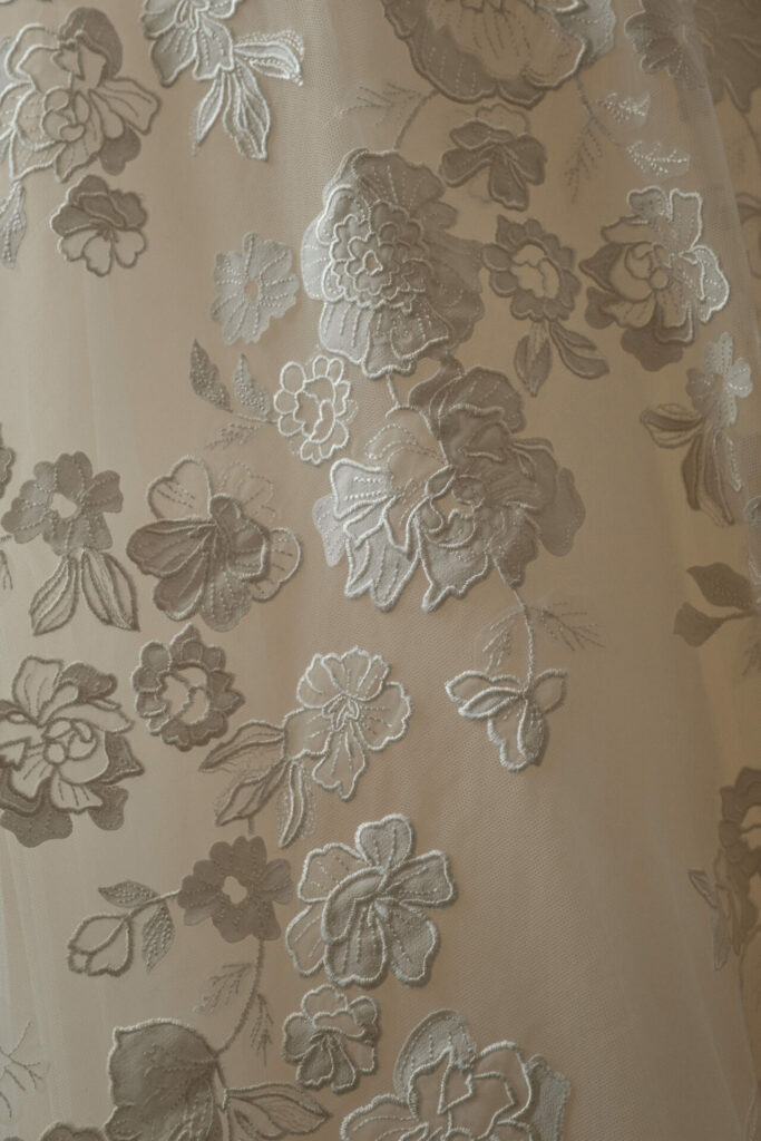 Sheer beige and silver floral embroidered fabric.