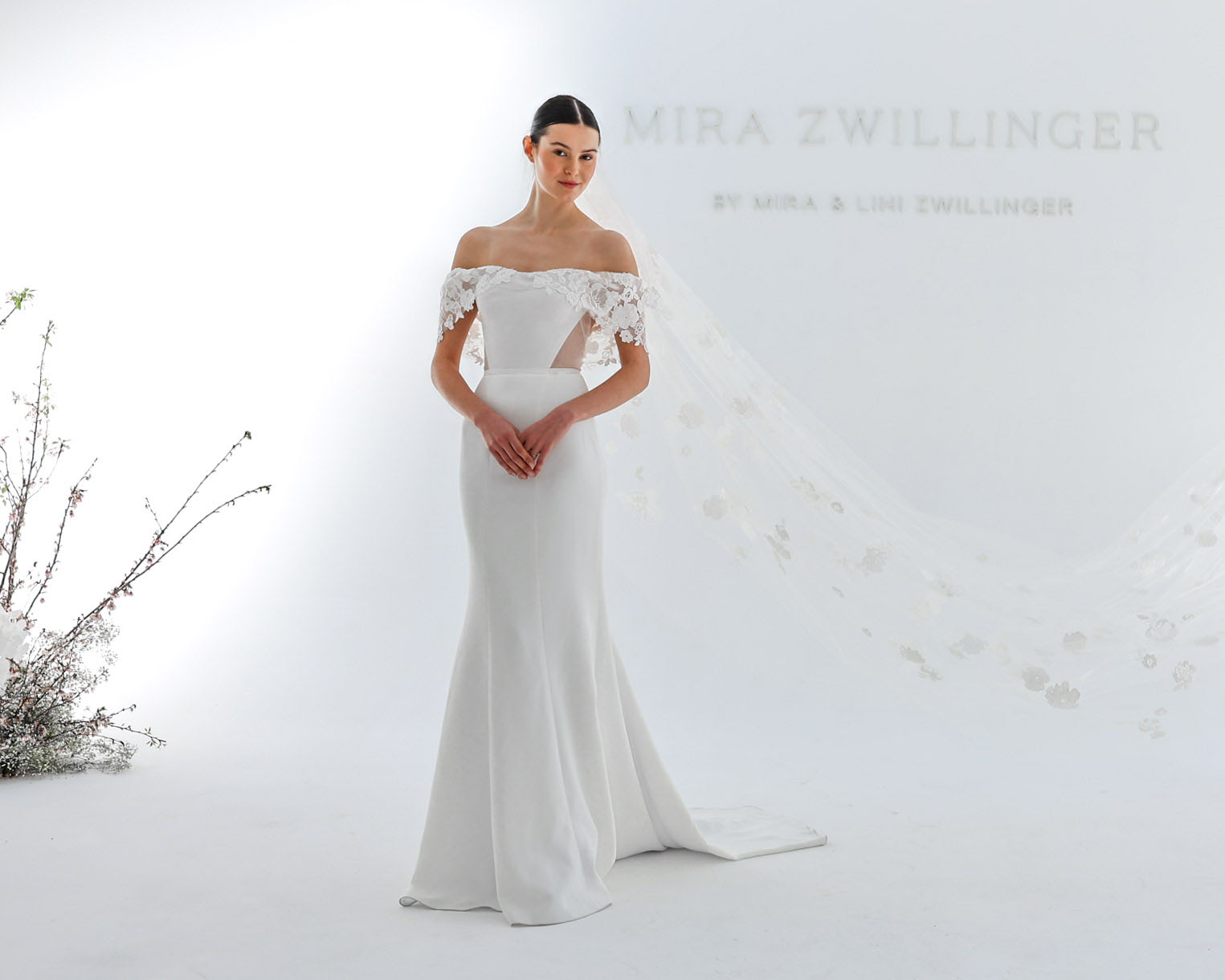 Bride in lace wedding dress, white background.