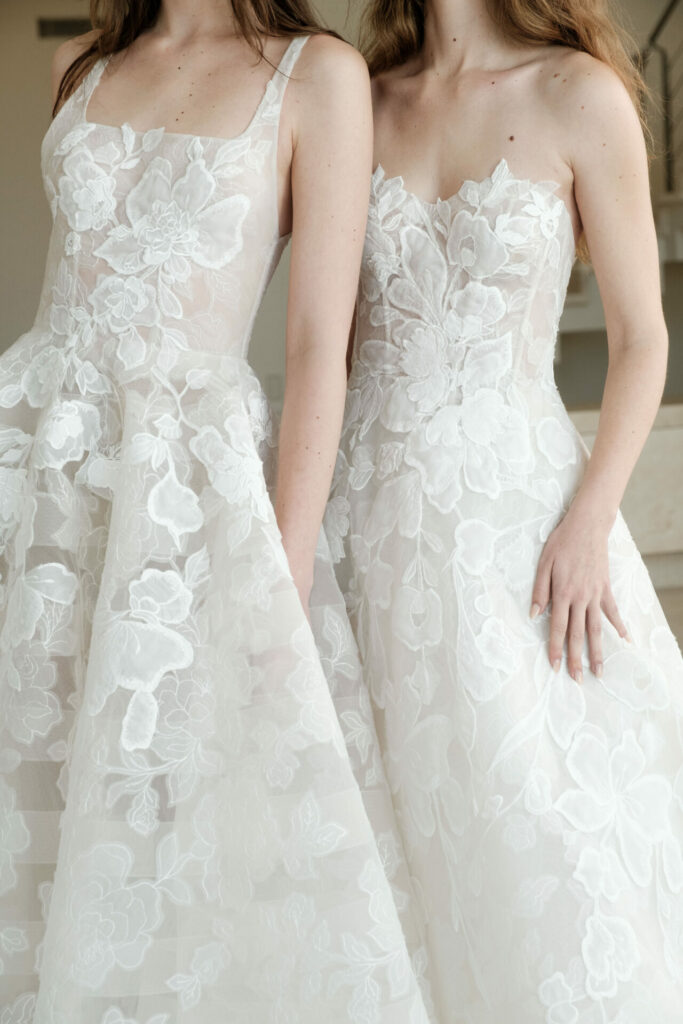 Two women in lace wedding dresses.