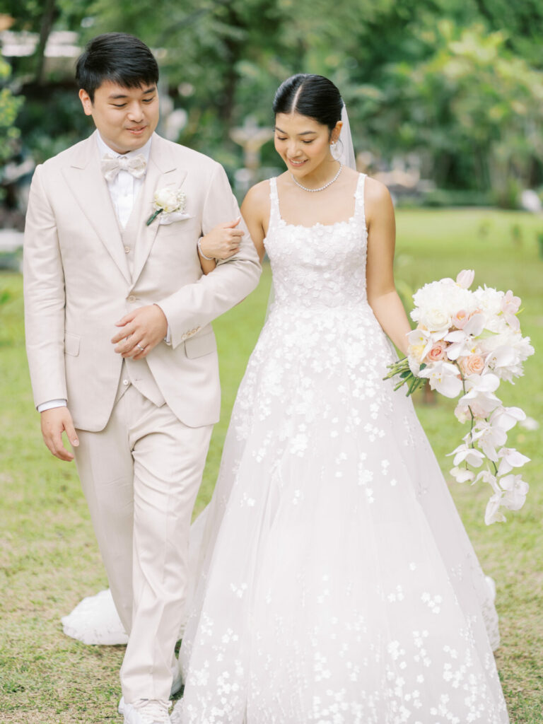 Katya Ruiz weds in couture, smiling outdoors.