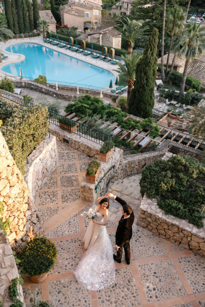 Bride and groom dance outdoors at wedding.