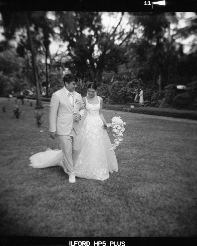 Bride Katya Ruiz and groom walk, smiling.
