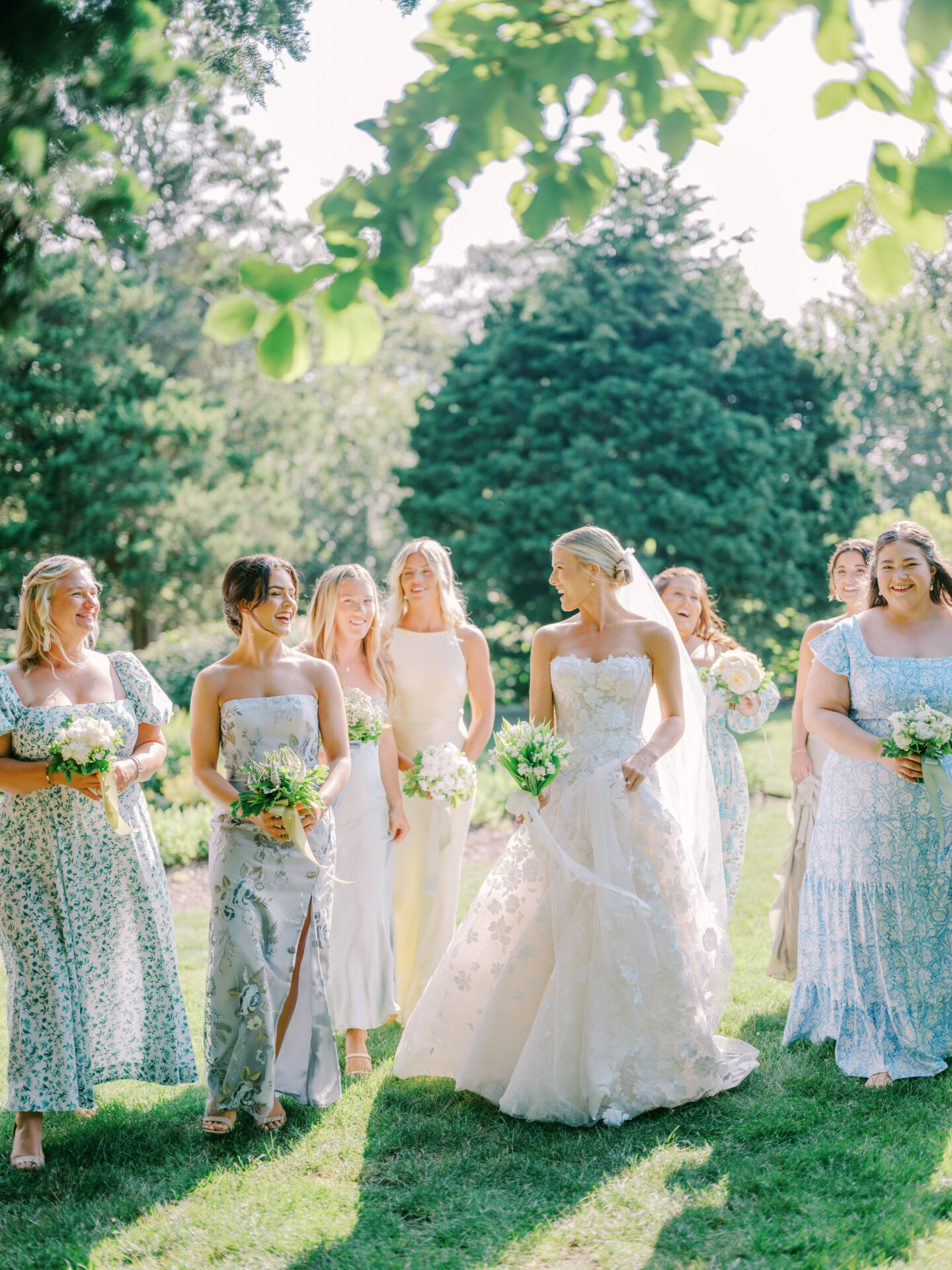 Smiling bride and bridesmaids walking outdoors.