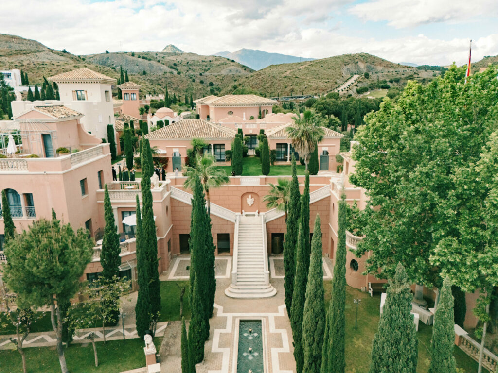 Mediterranean villa, gardens, mountains—luxury bridal setting.