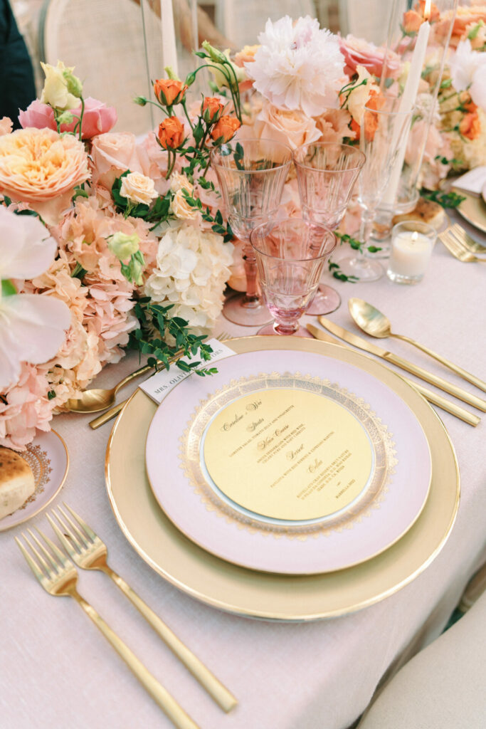 Romantic table: gold accents, pastel flowers, candlelight.