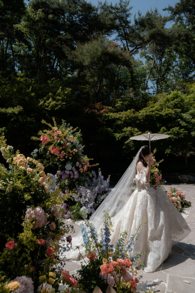 Bride Katya Ruiz outdoors in floral Mira Zwillinger gown.