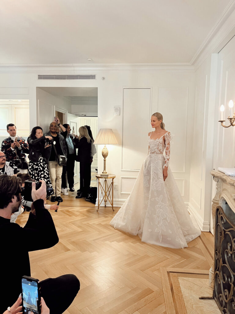 Bride poses for photos in elegant room.