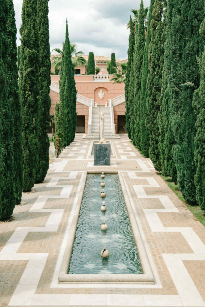 Formal garden, reflecting pool, cypress trees, bridal couture.