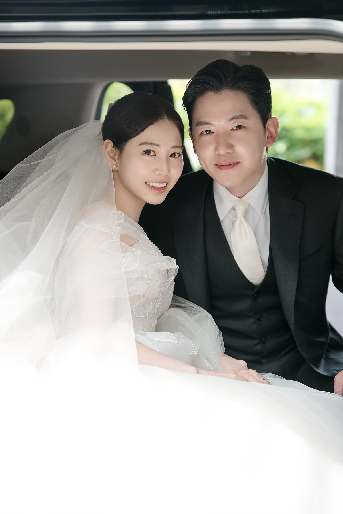 Bride and groom smiling together in soft light.