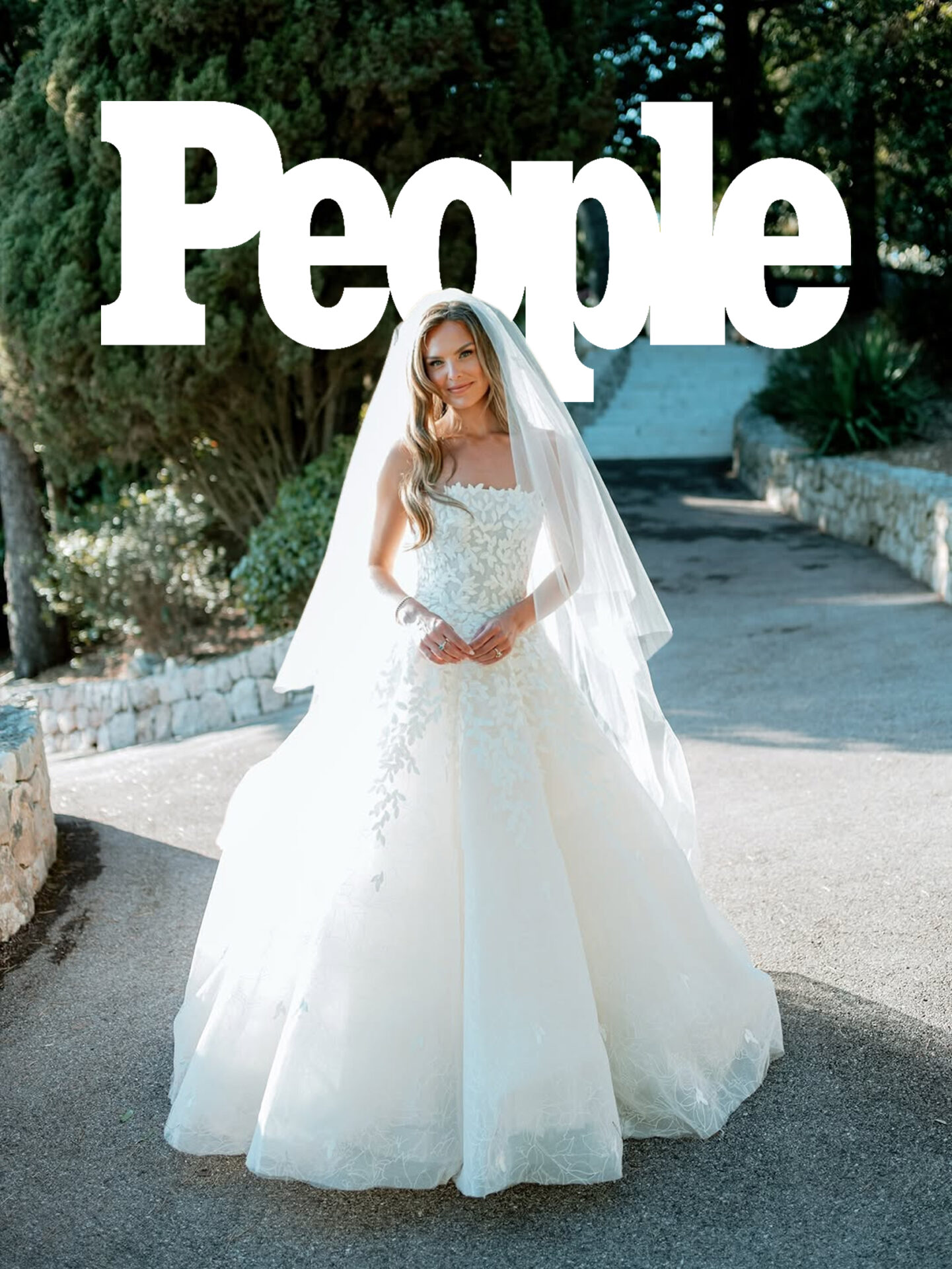 Bride in white gown outdoors, People logo above.
