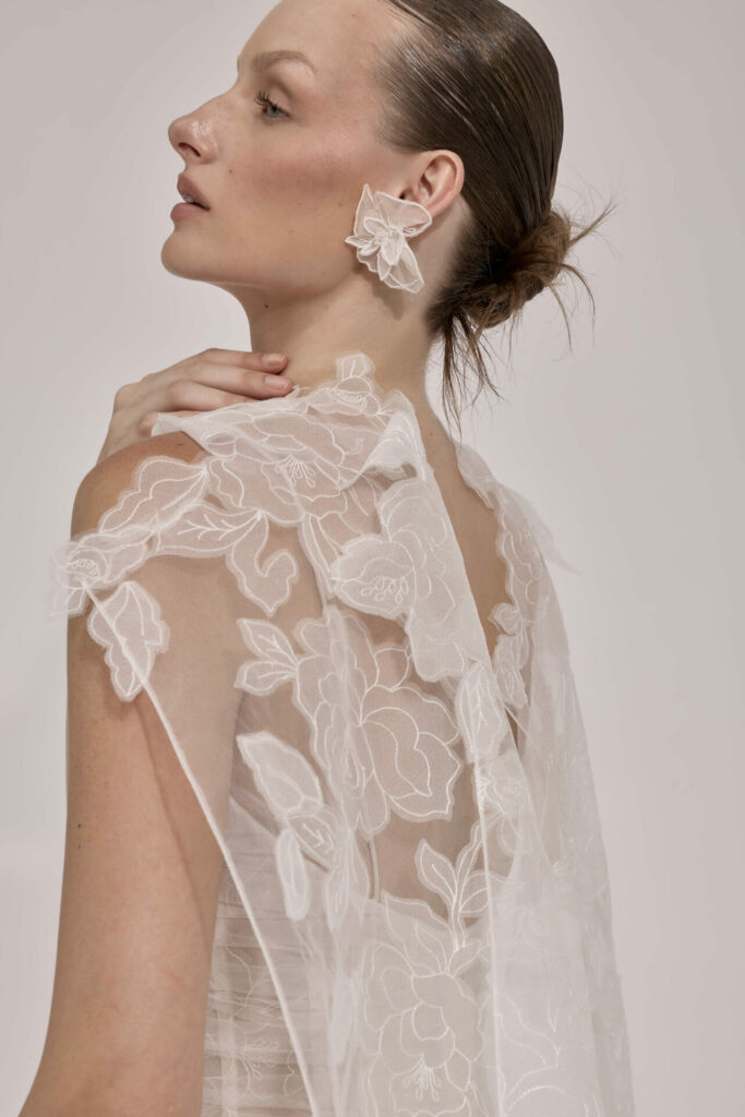 Woman in sheer floral lace, looking sideways.