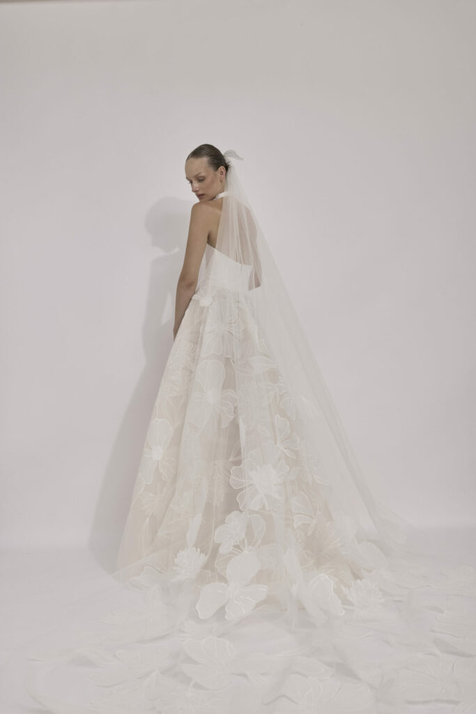 Bride in floral strapless gown and sheer veil.