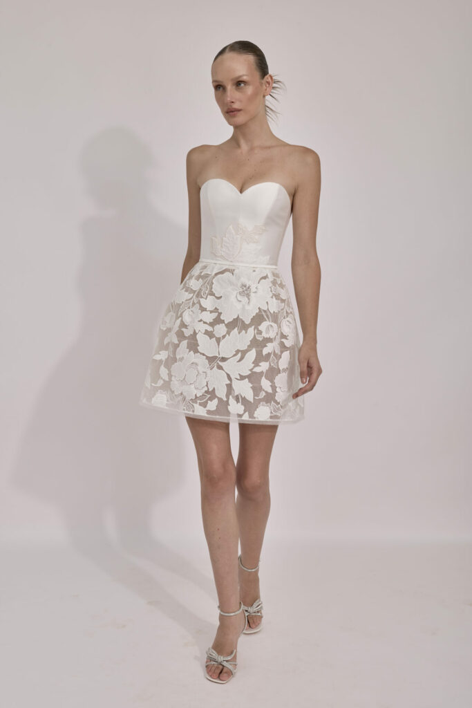 Woman in strapless white Jessey dress and heels.