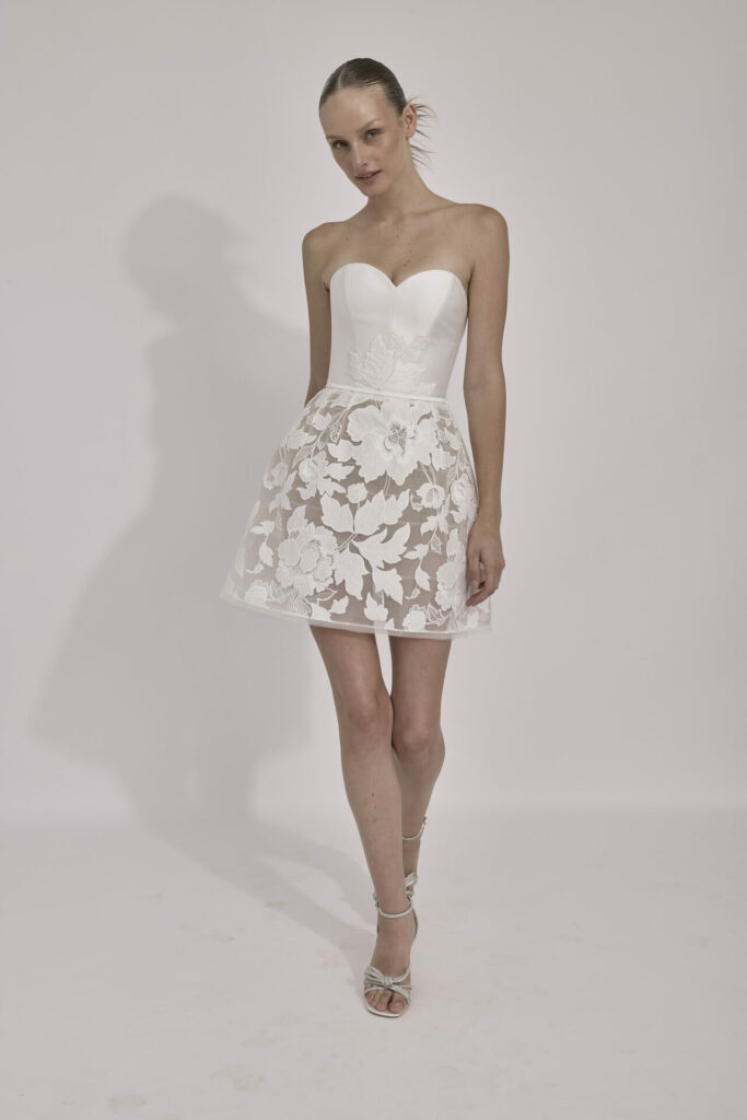 Woman in white strapless mini dress and heels.