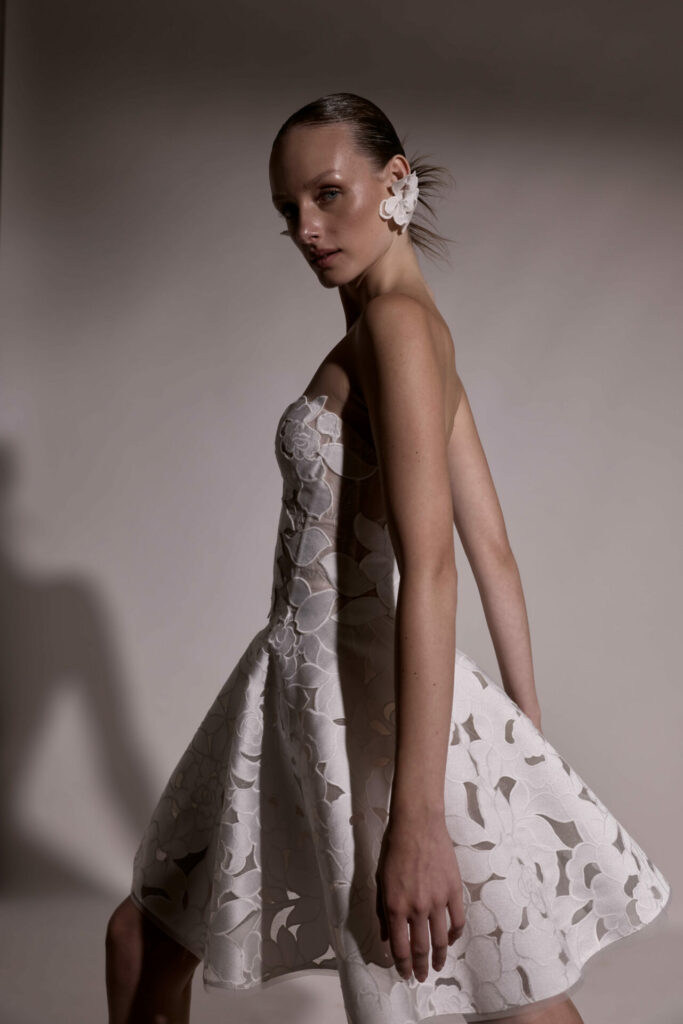 Woman in floral white dress, profile view.