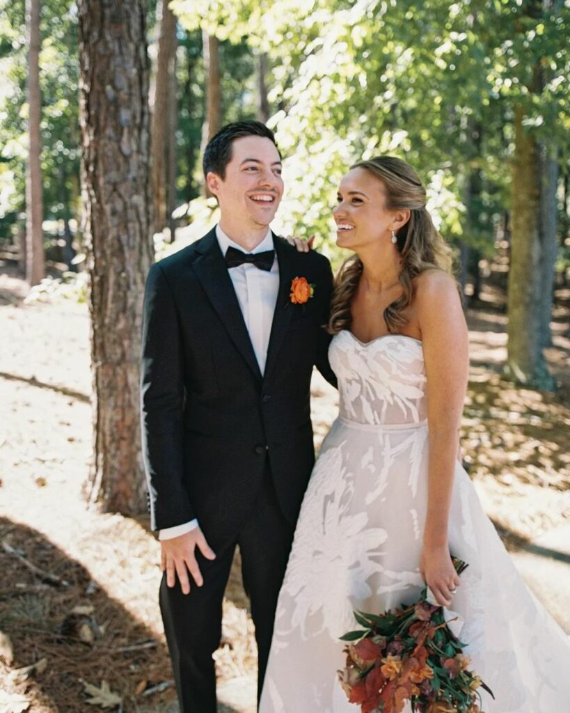 Bride in couture gown, groom in tux, forest wedding.