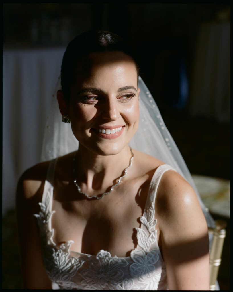 Smiling bride in luxe Mira Zwillinger gown, glowing.