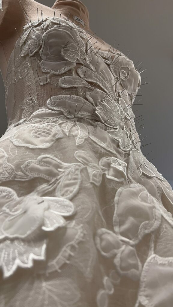 Dress form with pinned floral lace dress, SS2026.