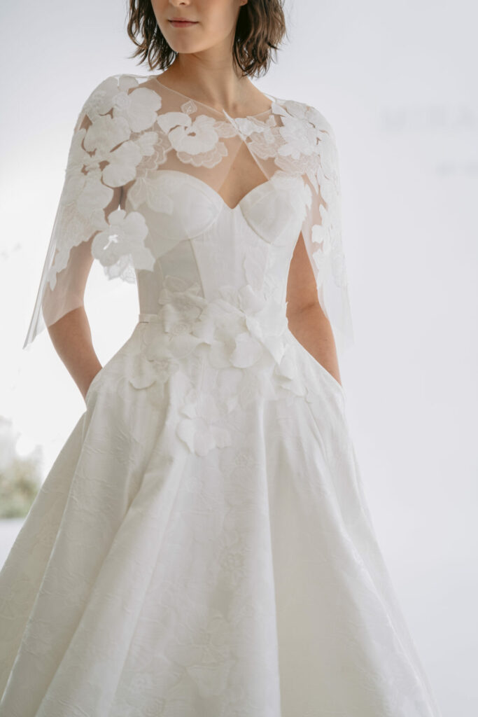 Woman in SS2026 "Far Beyond" wedding dress, dreamy background.