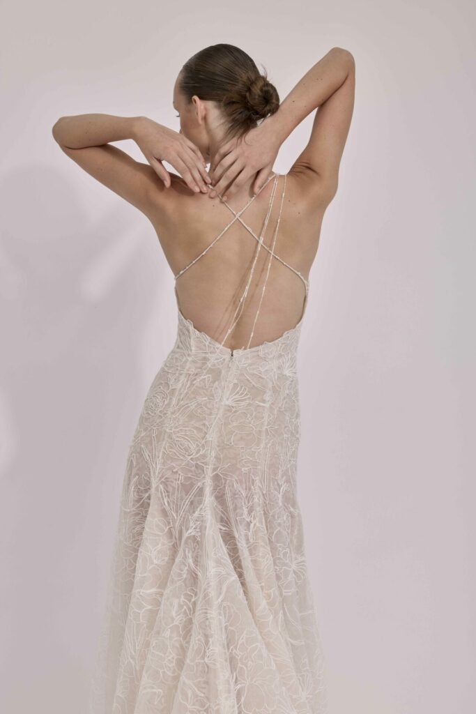 Woman in sheer lace dress, back to camera.