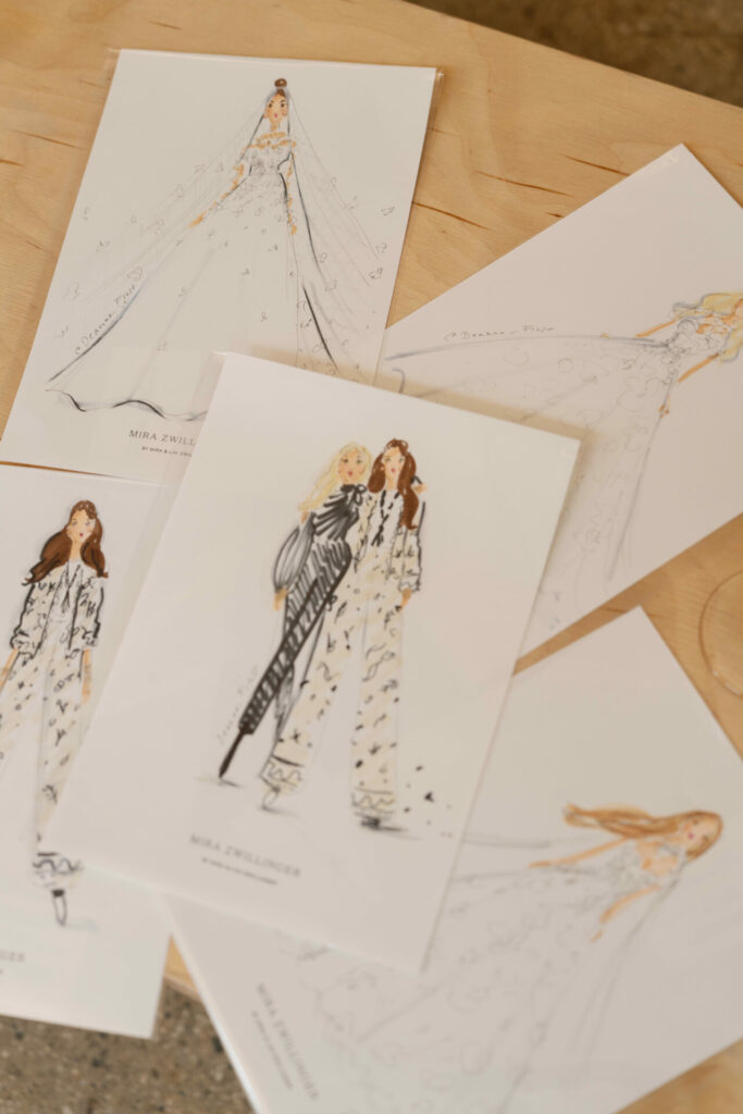 Fashion sketches of women in elegant SS2026 outfits.