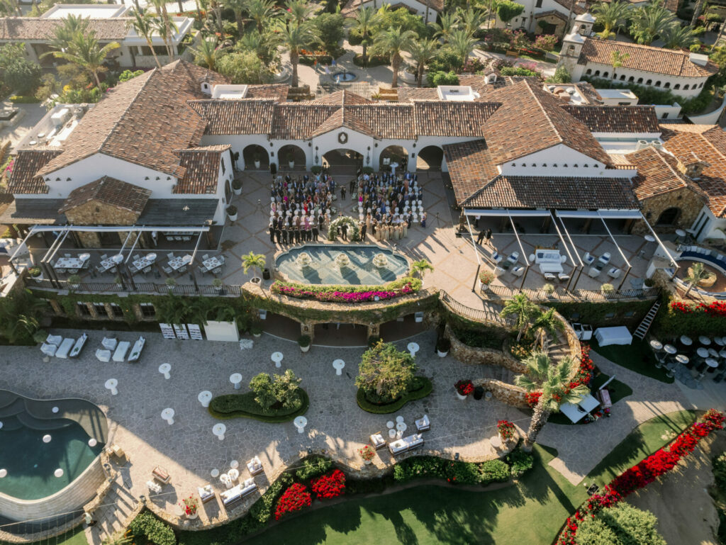 Mediterranean villa, tiled roof, courtyard event, lush gardens.