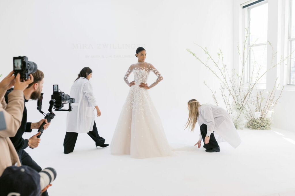 Model in SS2026 gown posed as dress adjusted.