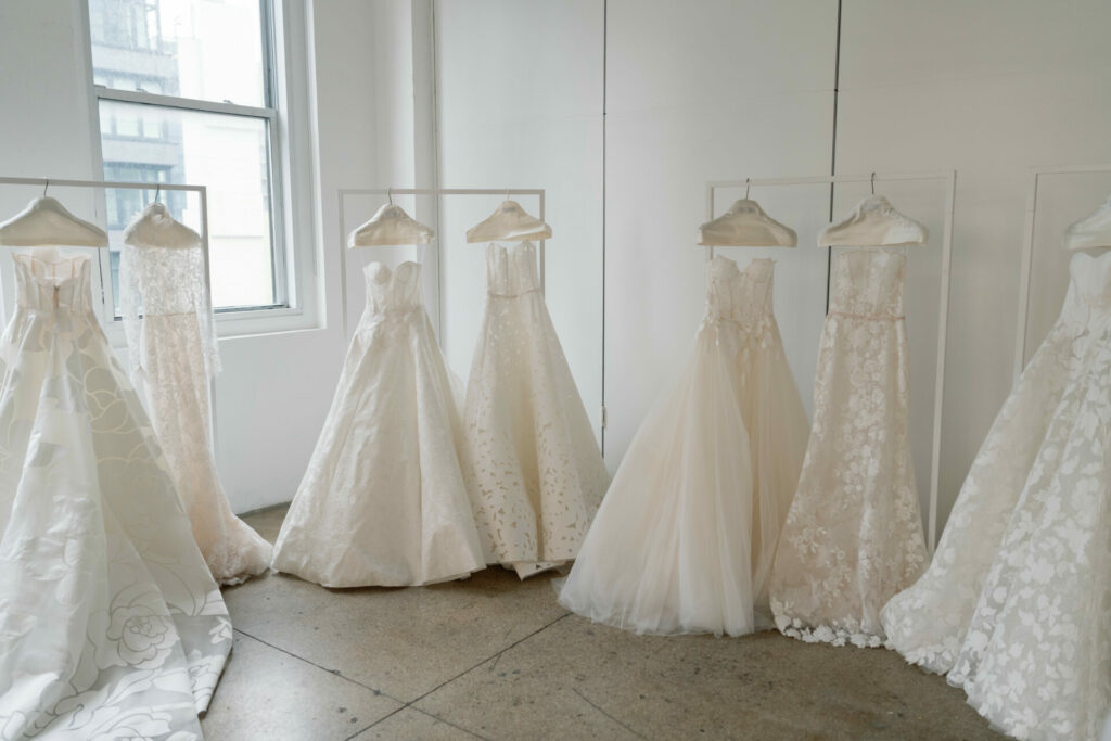 Six "Far Beyond" SS2026 wedding dresses lit by window.